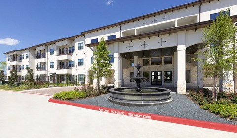 an exterior view of the main entrance to a senior apartment community