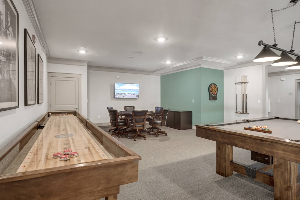 a game room with a pool table and a ping pong table