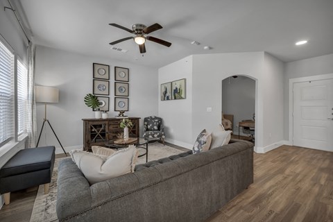 an open living room with a ceiling fan at a senior apartment community