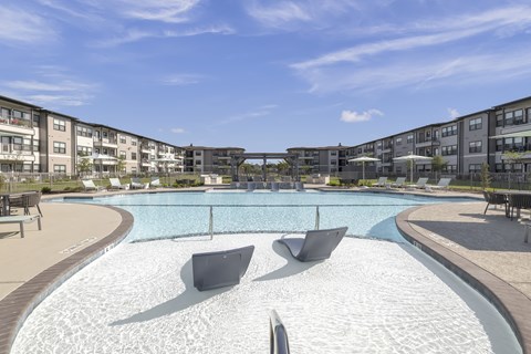 a resort-style pool and patio at a senior apartment community