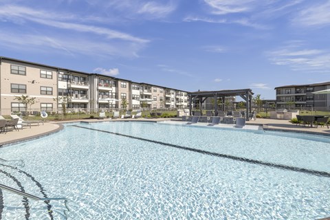 a resort-style pool and covered lounge area at a senior apartment community