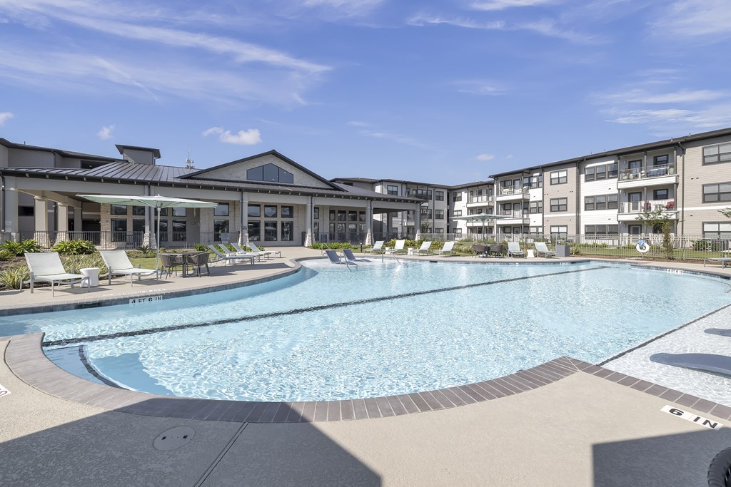 a resort-style pool and patio at a senior apartment community