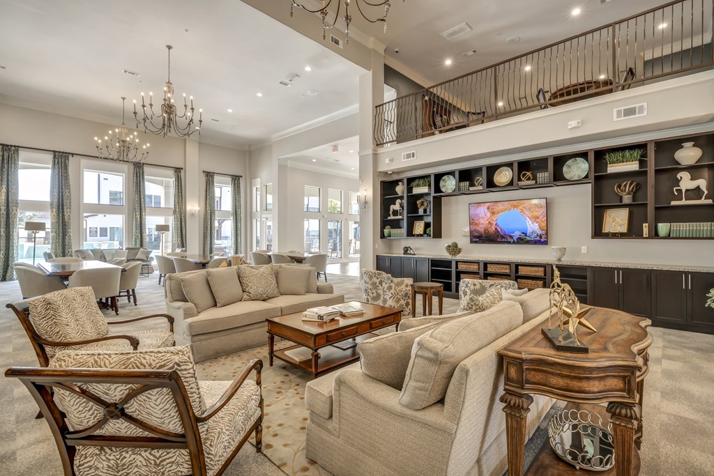 a living room with couches and chairs and a television