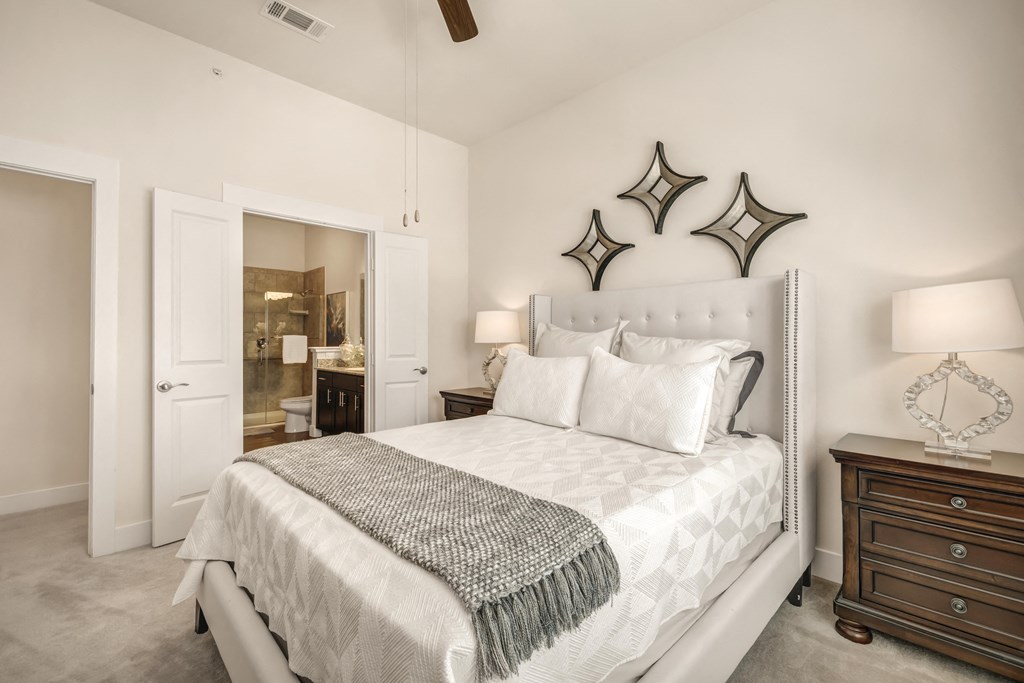 a white bedroom with a bed and two stars on the wall