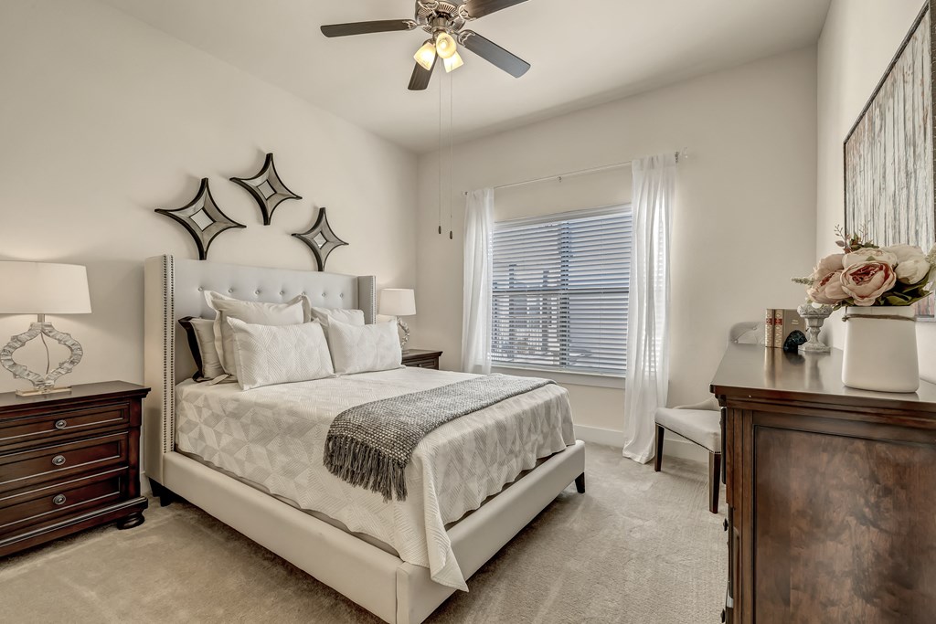 a bedroom with a bed and a ceiling fan