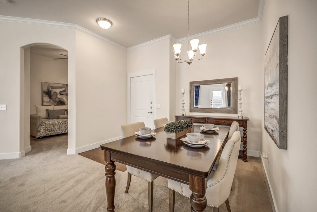 a dining room with a wooden table and chairs