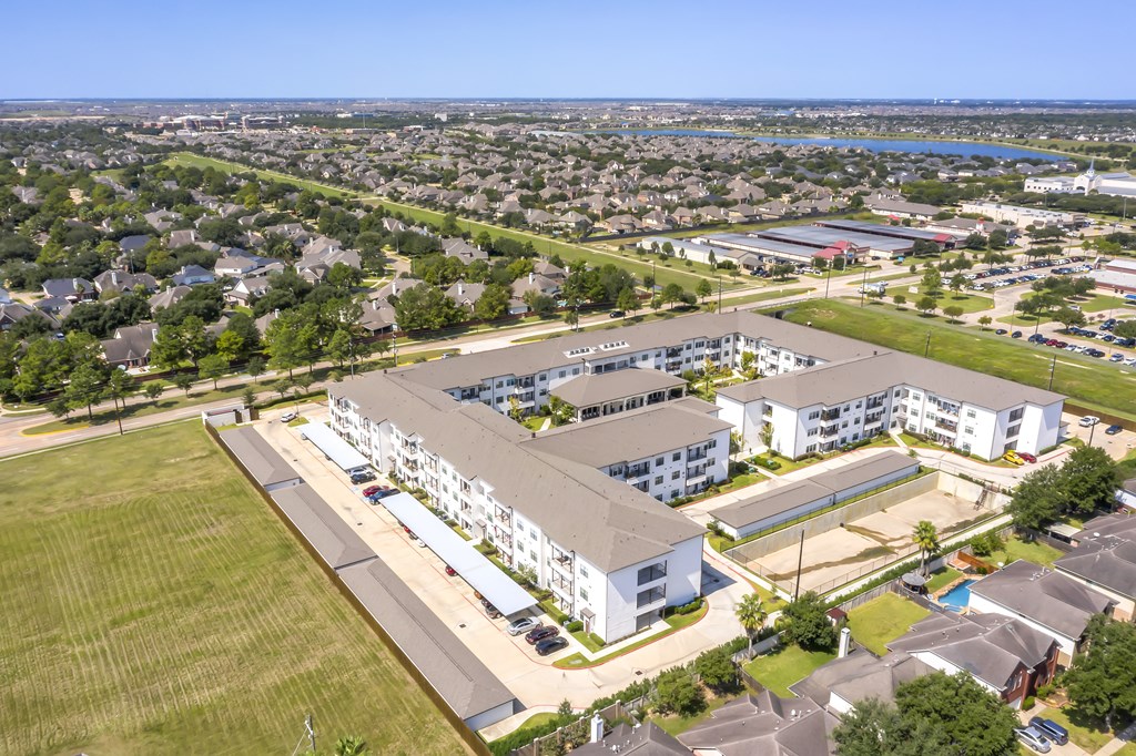 an aerial view of an apartment complex with a city in the background