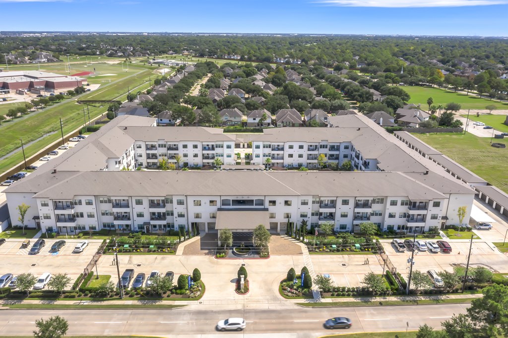 an aerial view of a large building in a parking lot