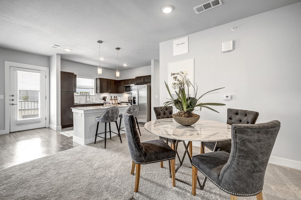 an open kitchen and dining room with a table and chairs