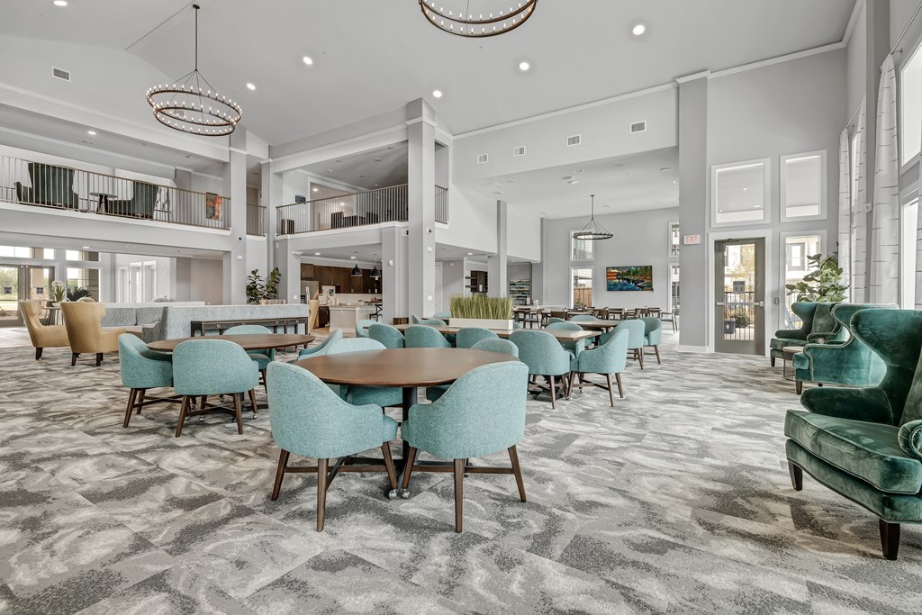 a large dining room with blue chairs and tables