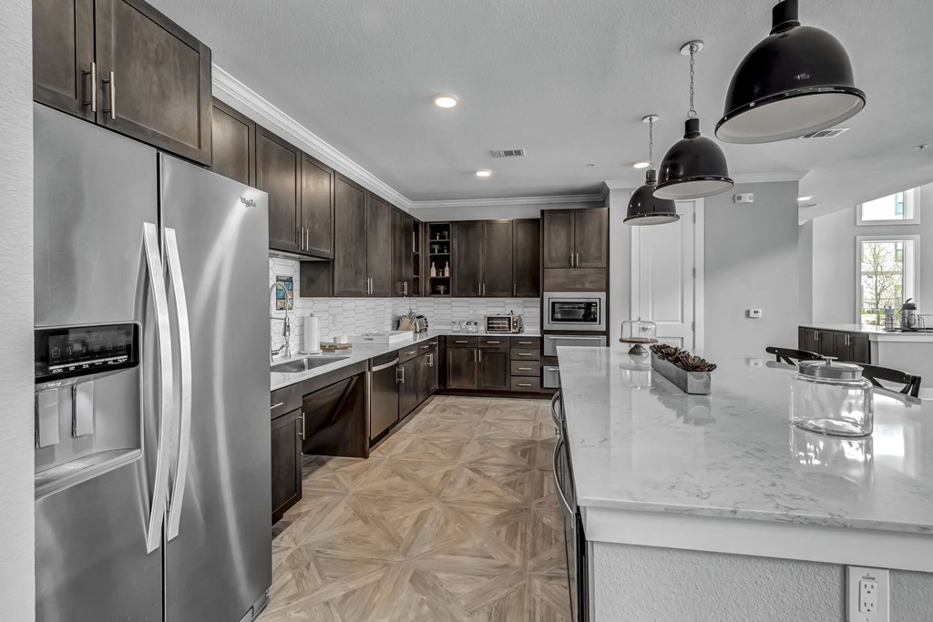 a kitchen with stainless steel appliances and marble counter tops