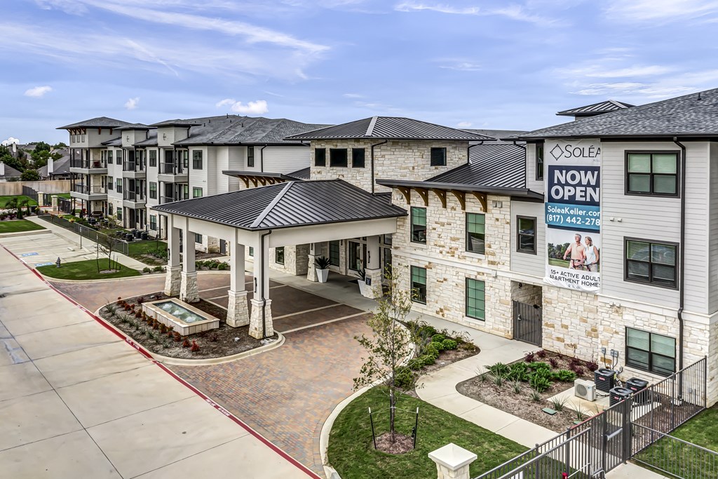an exterior view of an apartment building with a now open sign