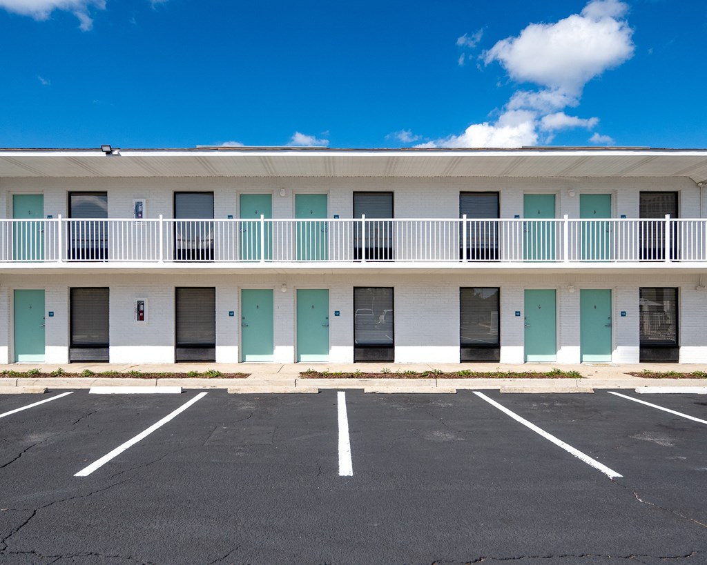 an empty parking lot in front of a building with balconies at The Teale Navy Yard, North Charleston, 29405