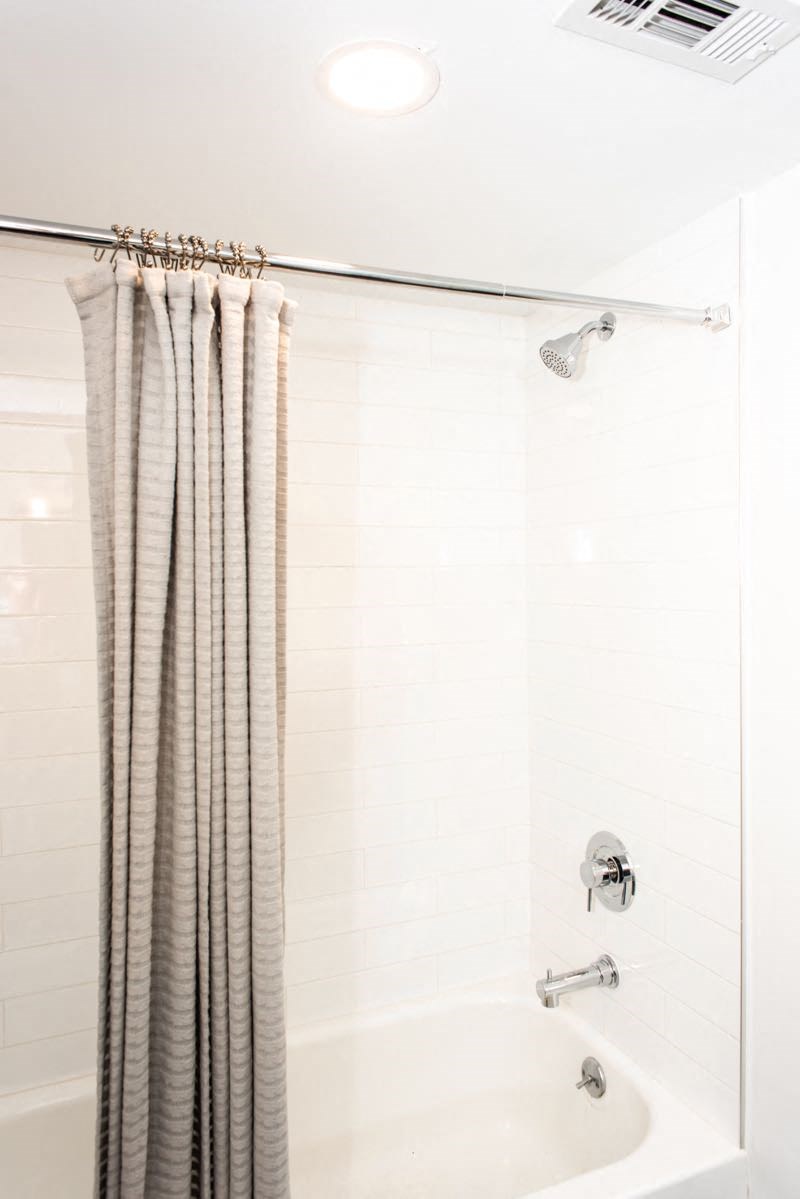 a bathroom with a tub and a shower curtain