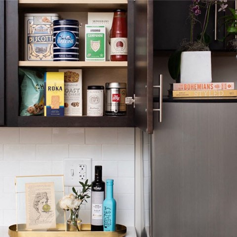 a shelf in a kitchen with medicines and other items on it