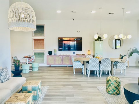 a living room with a table and chairs and a television