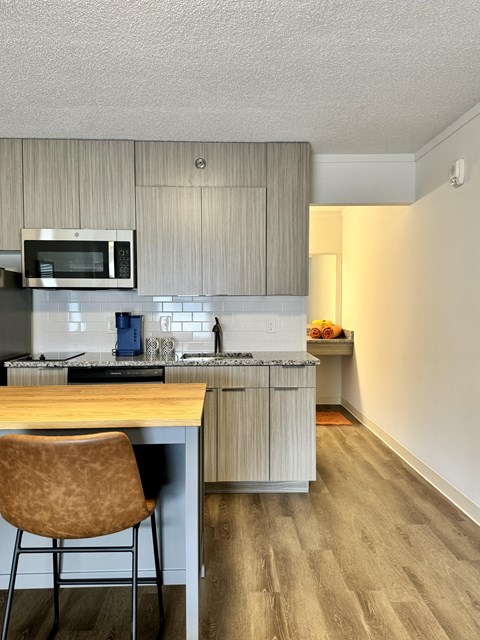 a kitchen with a island and a stove and a microwave