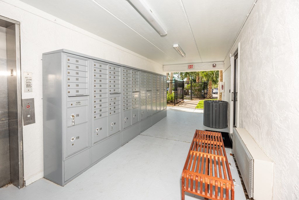 a locker room with a bench and some lockers at The Teale, Kissimmee, FL, 34746