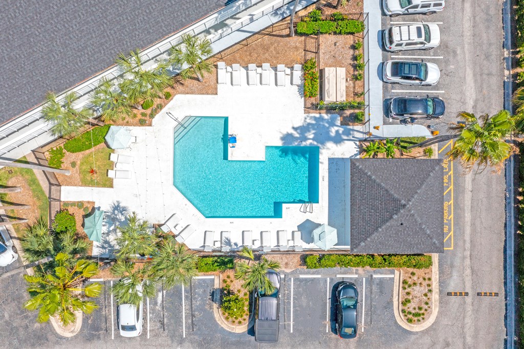 an overhead view of a pool in a parking lot with cars at The Teale, Kissimmee, FL, 34746