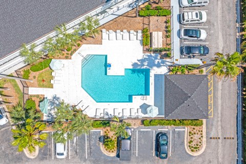 an overhead view of a pool in a parking lot with cars