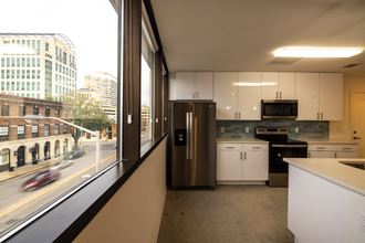 a kitchen with a window and a city view