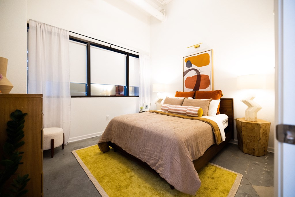 a bedroom with a bed and a large window  at The Lady, Columbia, SC, 29201