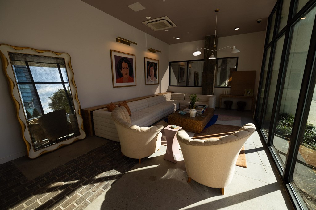 a living room with a couch and chairs and a large window  at The Lady, Columbia, SC, 29201