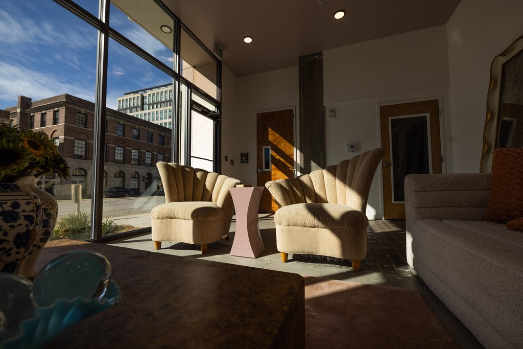 a living room with chairs and a table and a large window  at The Lady, South Carolina