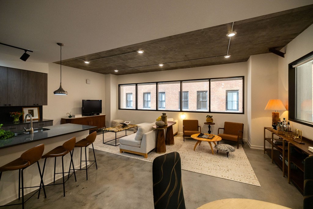 a living room with a kitchen and a large window  at The Lady, Columbia, SC, 29201