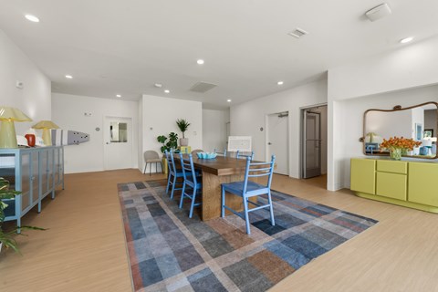 A dining room with a blue rug and chairs.at The Teale New Haven Apartments, Melbourne, FL, 32904