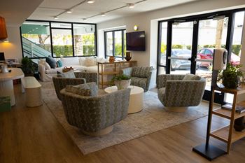 a living room with couches and chairs and a tv at The Teale, Kissimmee, FL, 34746