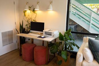 a desk with a computer and a printer on it at The Teale, Kissimmee, FL, 34746