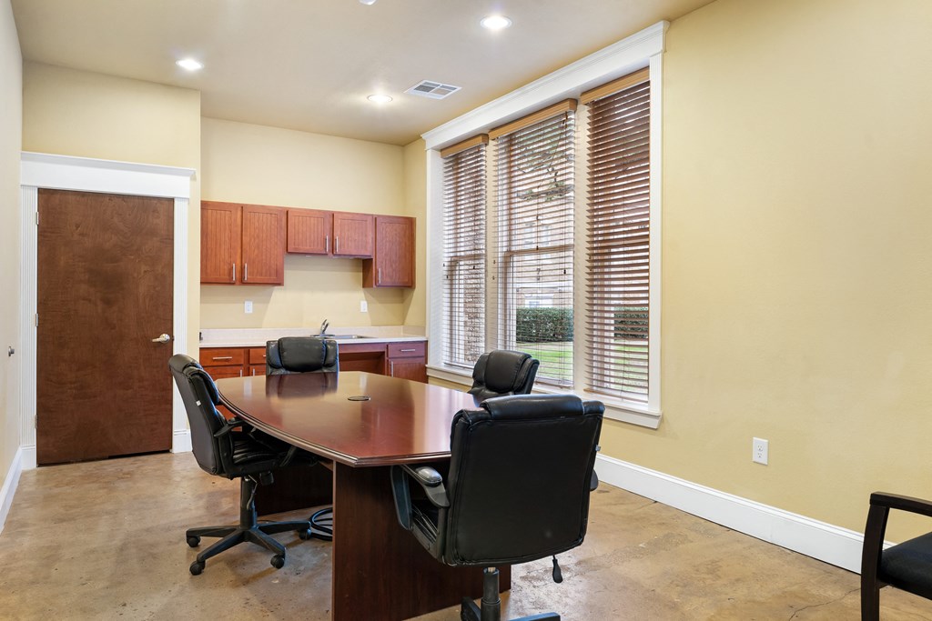 a conference room with a wooden table and chairs