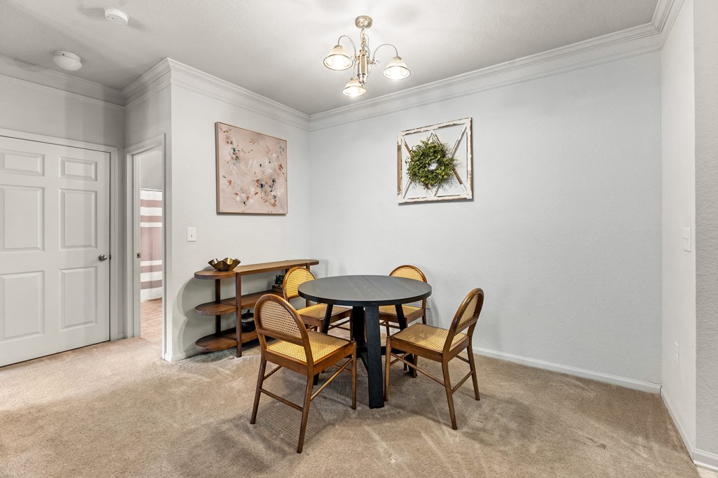 a dining room with a table and chairs and a door