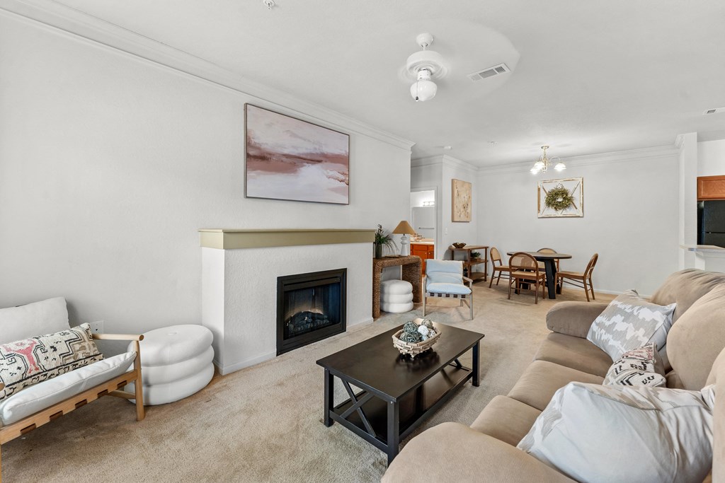 a living room with a couch and a table and a fireplace