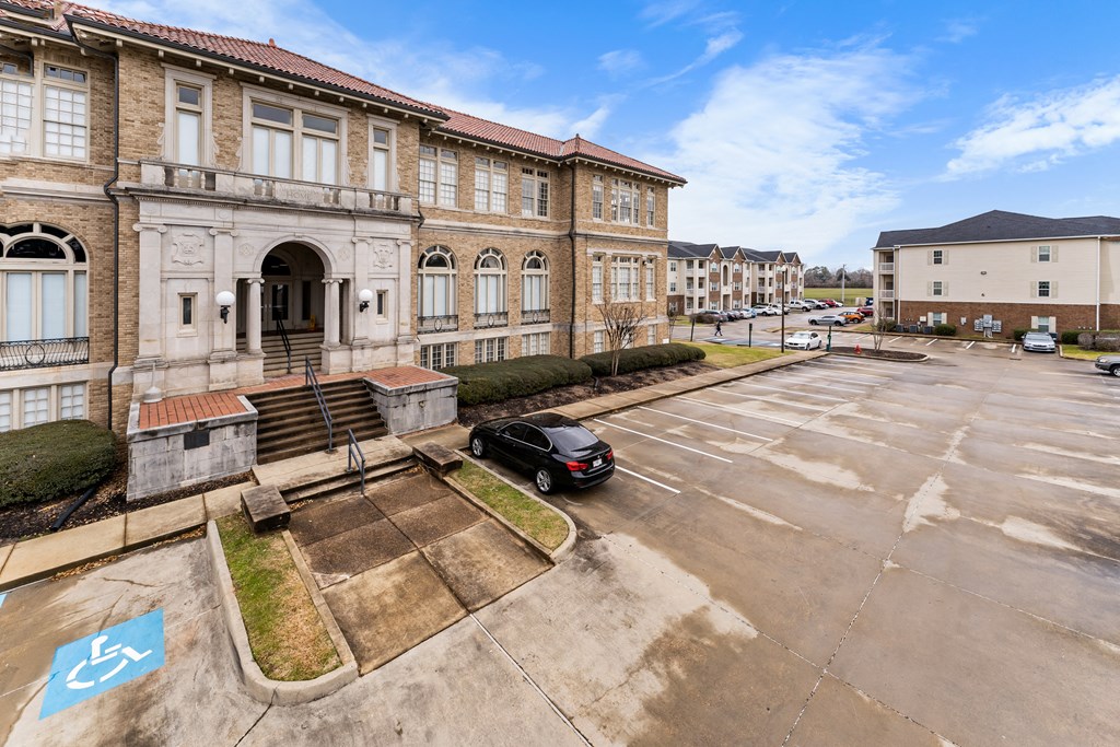 a car parked in a parking lot in front of a building