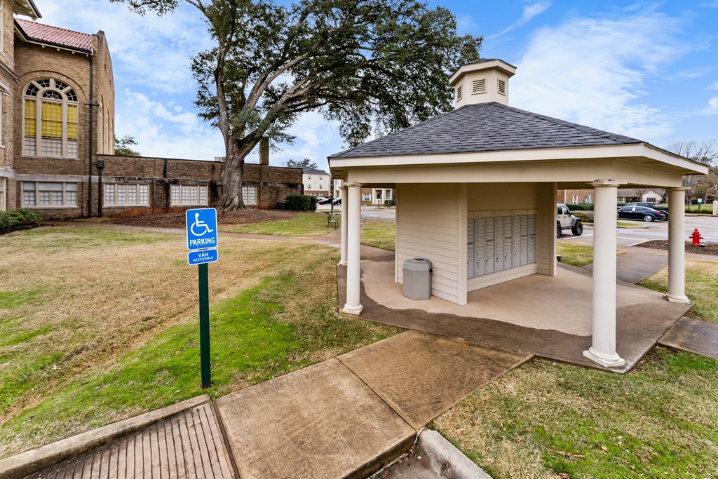 a handicapped accessible bathroom in front of a church with a blue handicapped sign