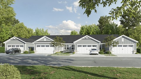 A large house with a grey roof and white garage doors.