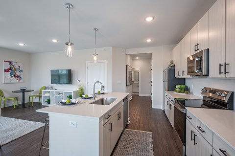A modern kitchen with white cabinets and a large island.