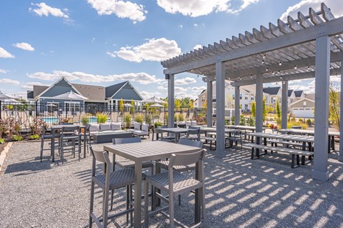 A sunny day at an outdoor dining area with tables and chairs.