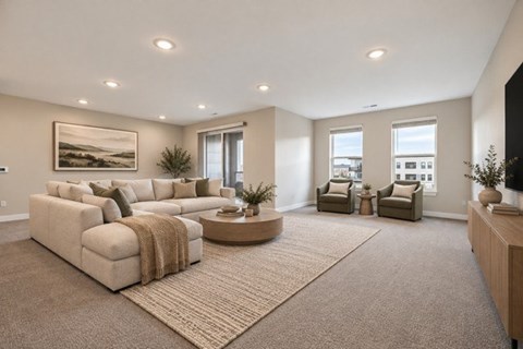 A living room with a large sectional sofa and a coffee table.