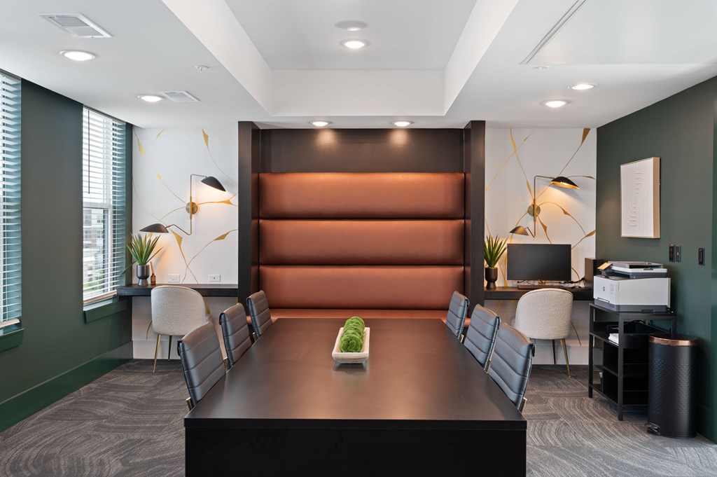 A conference room with a long table and chairs.