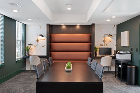 A conference room with a long table and chairs.