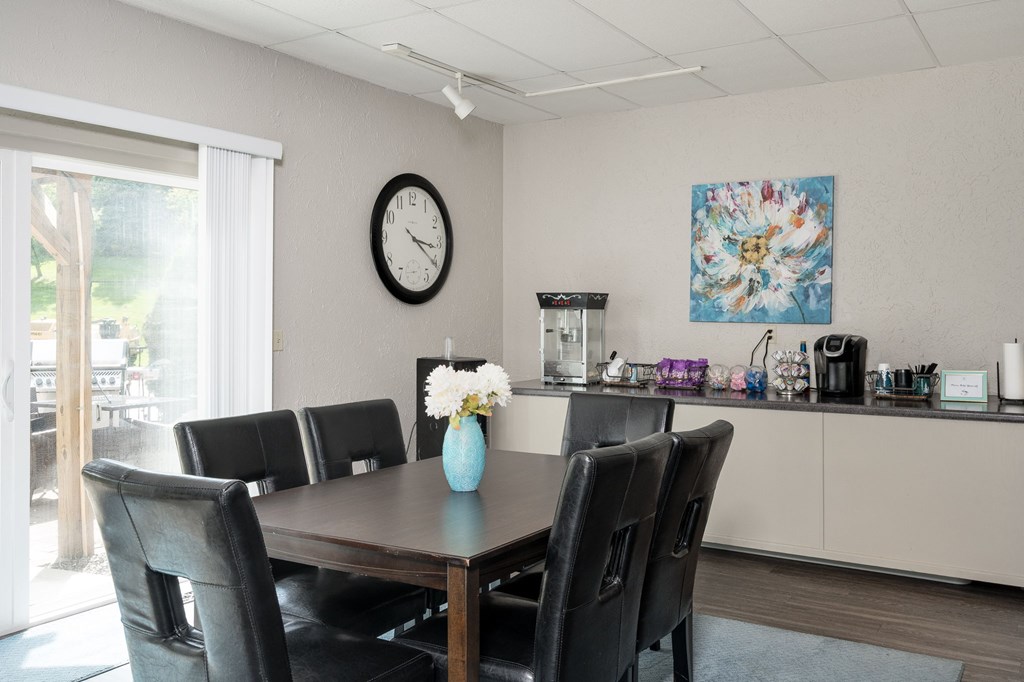 A dining room with a table set for six.