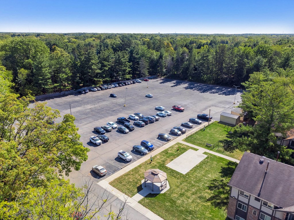 A parking lot with cars and a building in the background.