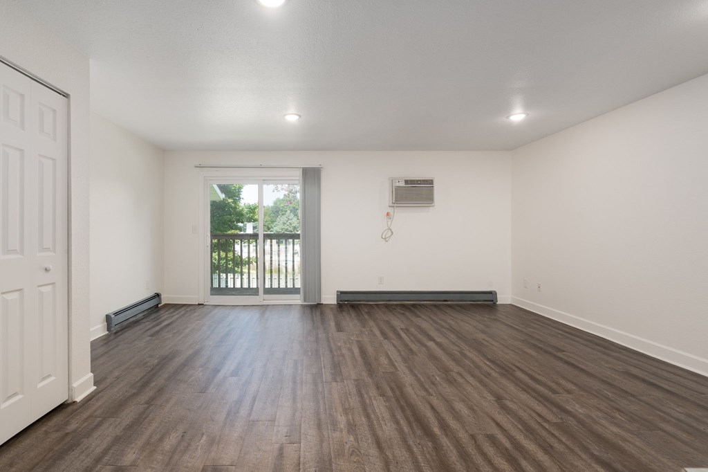 A room with wooden floors and white walls.