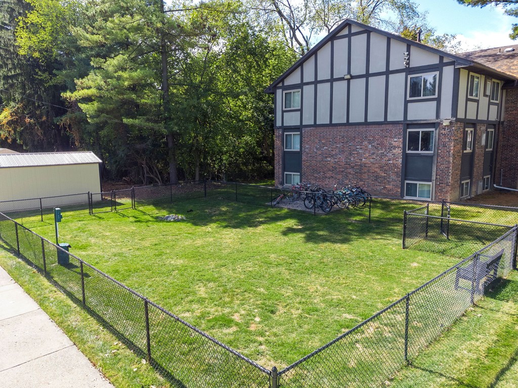 A black and white house with a green lawn in front.