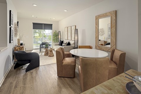A modern living room with a round table and chairs.