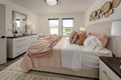 A bedroom with a large bed and a window.