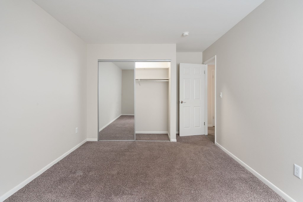 A room with a carpeted floor and white walls.